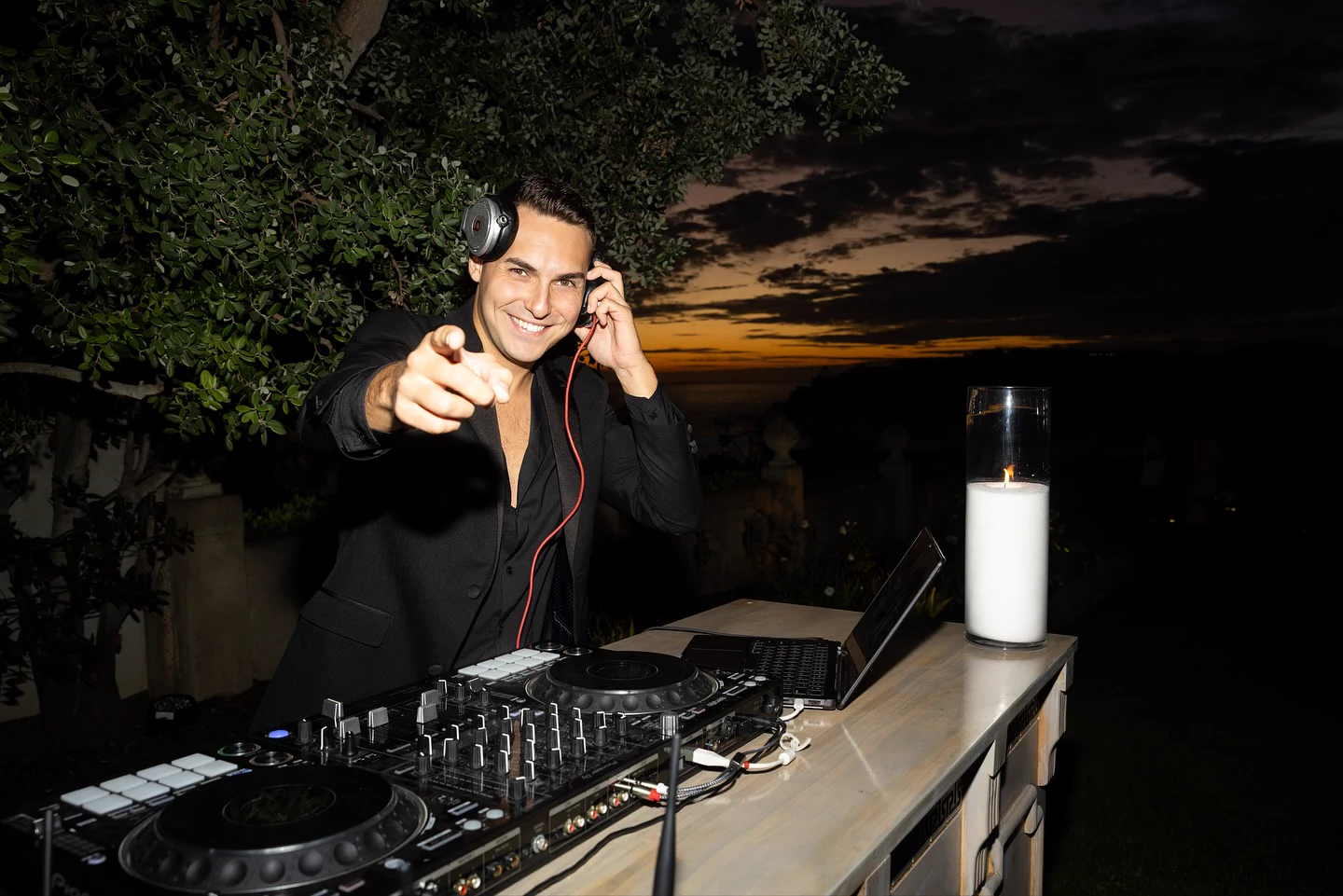 DJ ART behind the decks at an oceanfront event