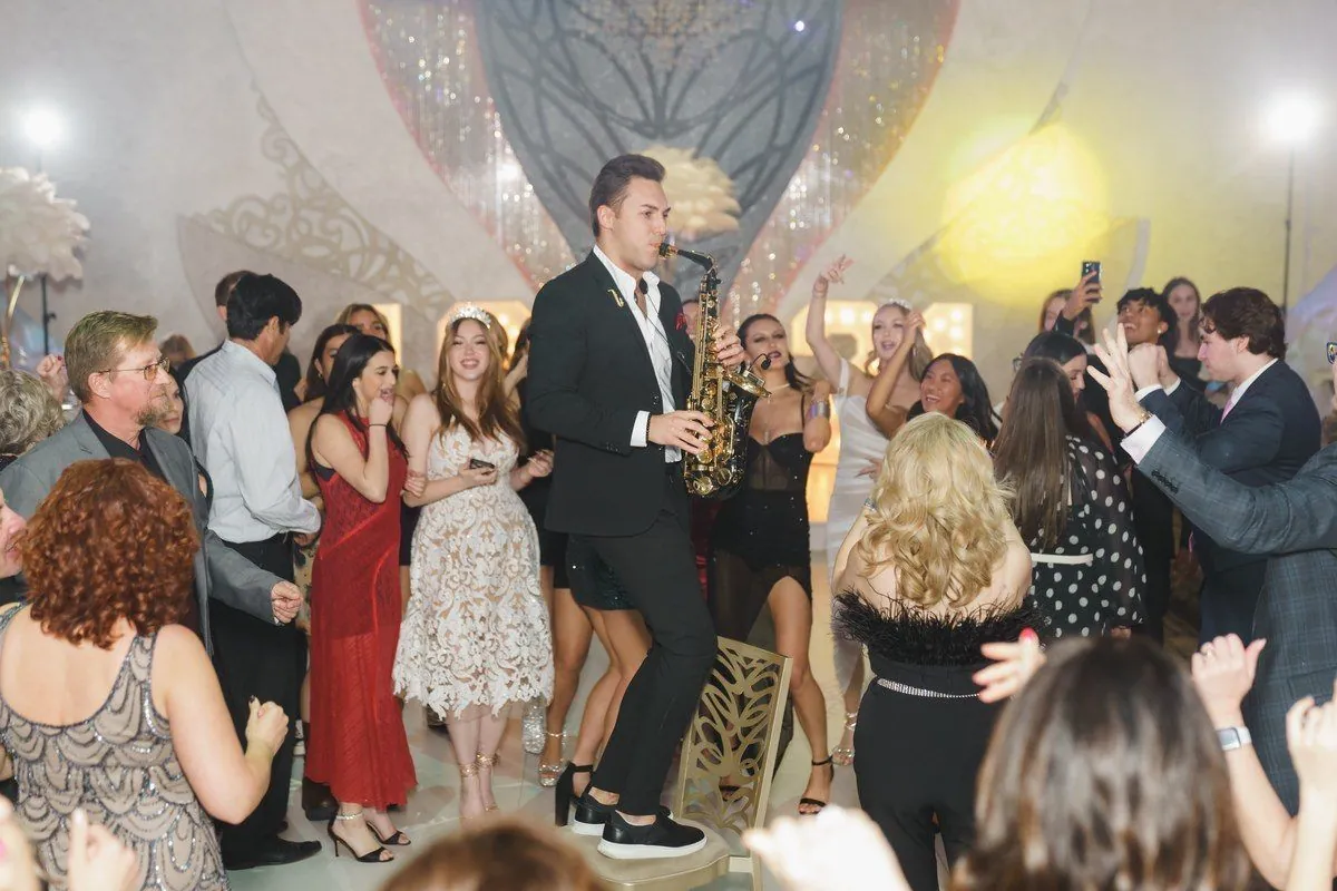 Saxophonist playing in the middle of a wedding dance floor